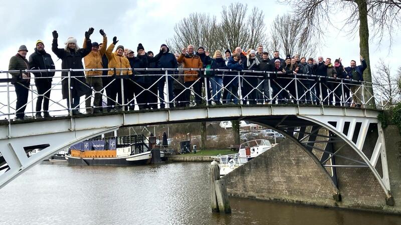 Group of participants standing on a bridge over a canal. © CWSS.