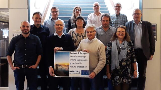 Participants of the Esbjerg meeting standing in front of stairs. © Nationalpark Vadehavet.