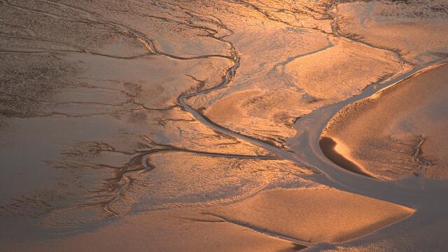 Aerial image of tidal flat in sunset colours. © CWSS/ Martin. Stock.