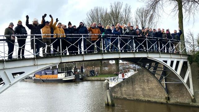 Group of participants standing on a bridge over a canal. © CWSS.